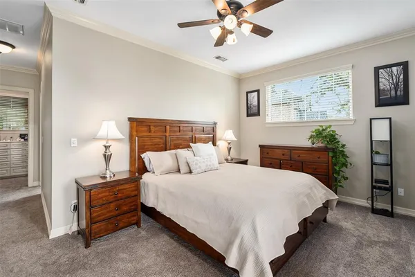 a bedroom with bed and a chandelier