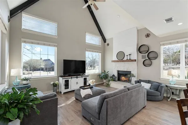 a living room with furniture a large window and a flat screen tv