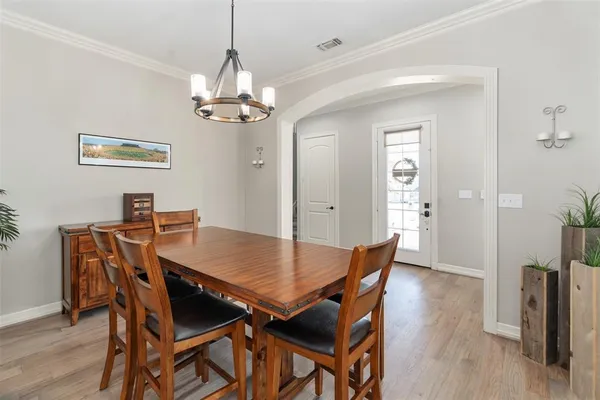a view of a dining room with furniture wooden floor and a chandelier