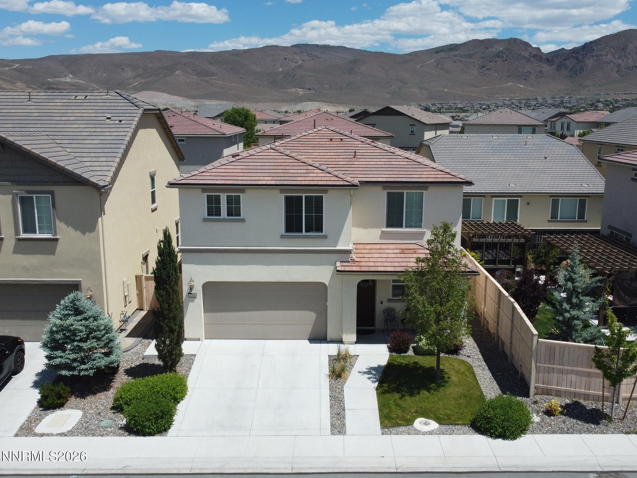 9766 Pachuca Drive Reno, NV 89521 - Photo 3 of 59 front view of house with a garden