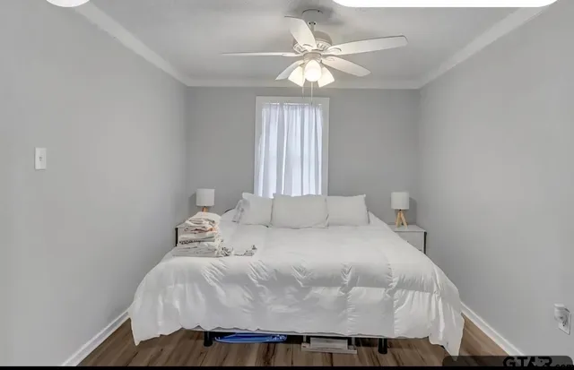 a bedroom with a bed and window