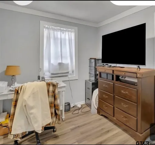 a room with wooden floor and furniture