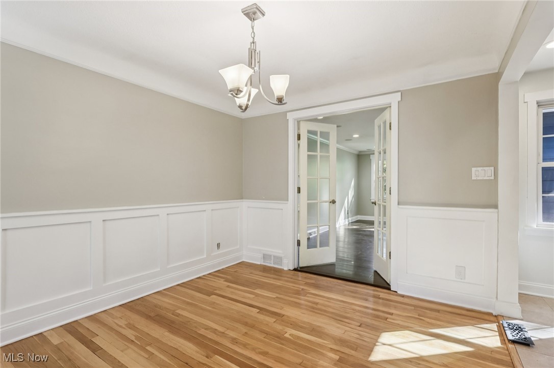 1151 Croyden Road Lyndhurst, OH 44124 - Photo 5 of 37 floors, french doors, a chandelier, a wainscoted wall
