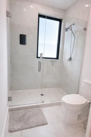 a bathroom with a toilet and a shower