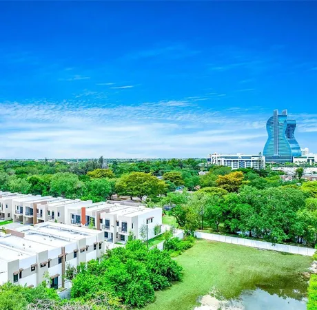 a view of a city with tall buildings and a yard
