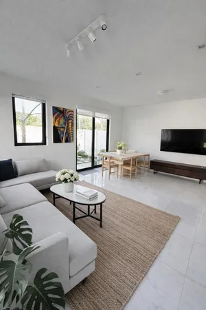 a living room with furniture wooden floor and windows