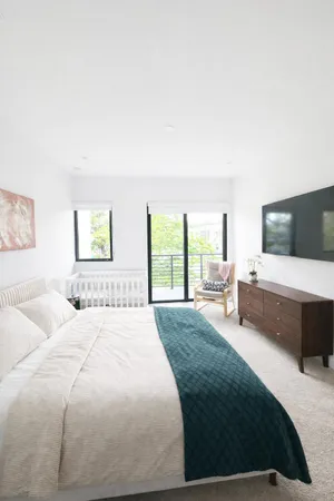 a bedroom with a bed and a flat screen tv