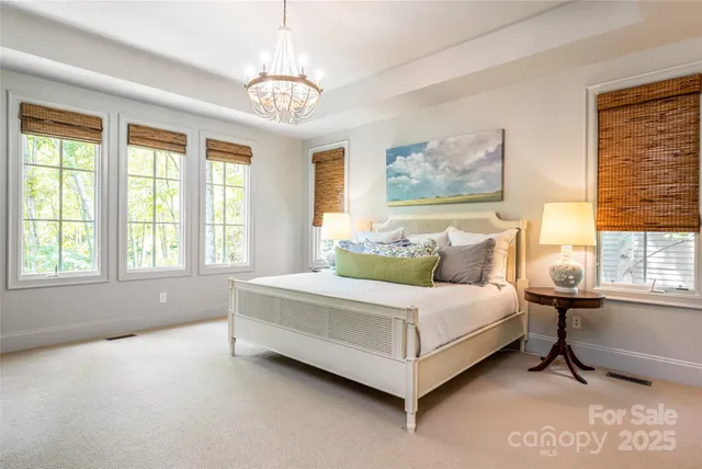 a spacious bedroom with a bed and window