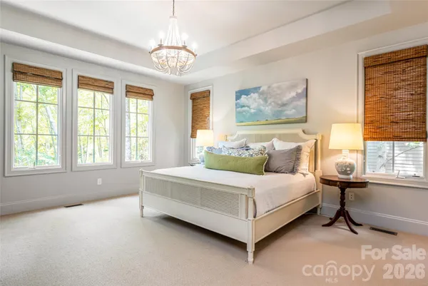 a spacious bedroom with a bed and window