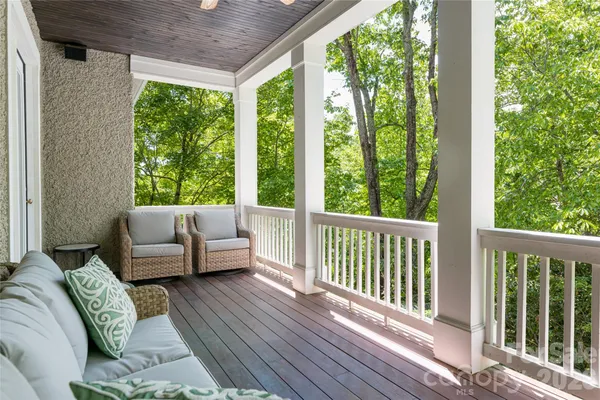 a balcony with furniture and wooden floor