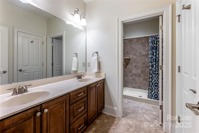 a bathroom with a sink double vanity and a mirror