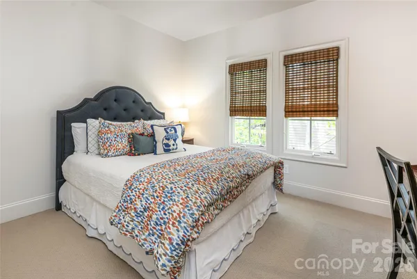 a bedroom with bed and a window