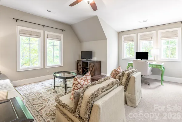 a living room with furniture fireplace and window
