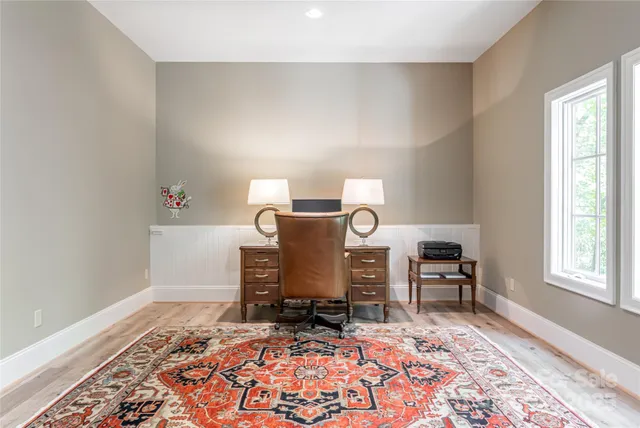 a living room with furniture rug and window