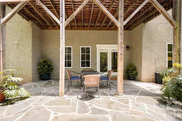 a building outdoor space with patio furniture and potted plants