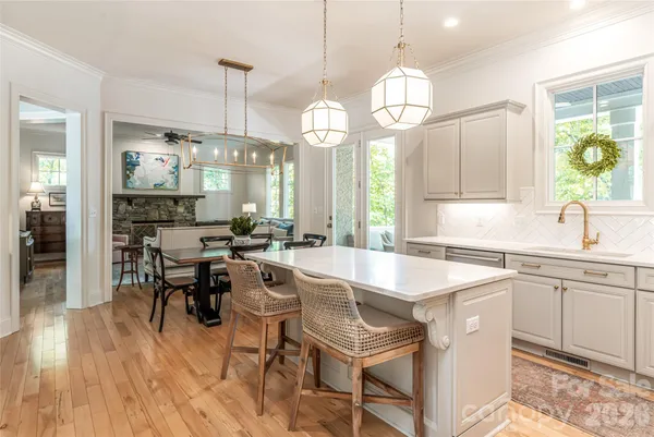 a large kitchen with a table and chairs
