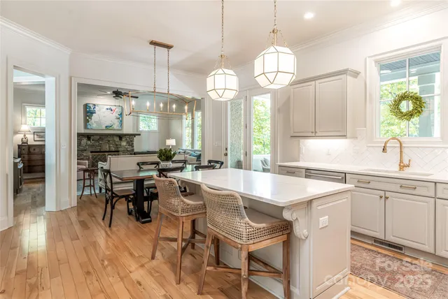 a large kitchen with a table and chairs