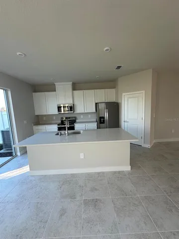 a white toilet sitting in a bathroom next to a window