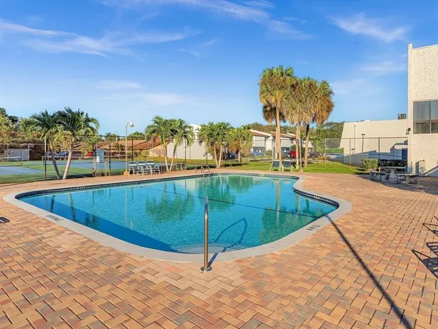 a view of a swimming pool with a lounge chair