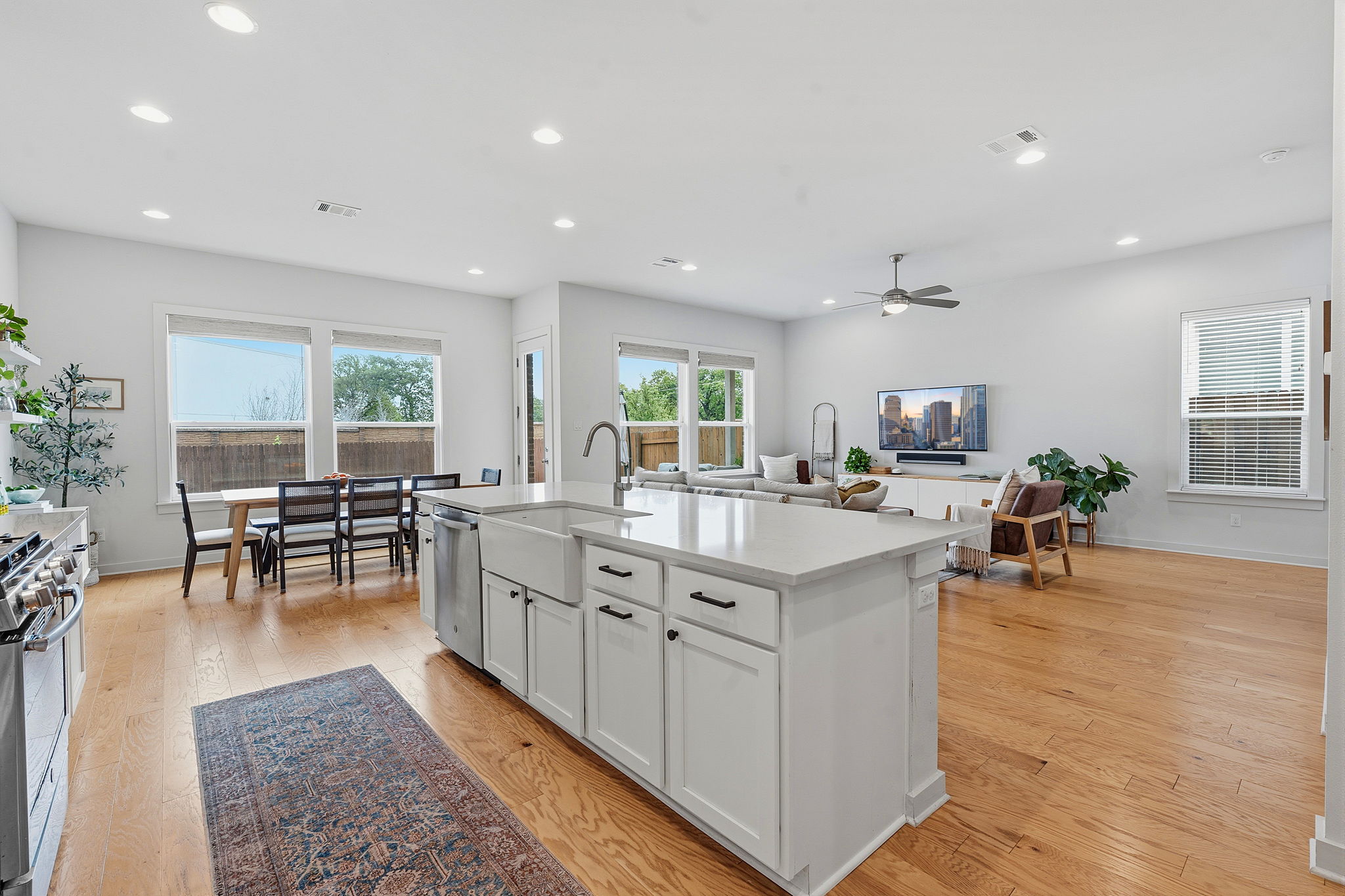 900 Old Mill Road, Unit 46 Cedar Park, TX 78613 - Photo 30 of 30 Kitchen with open floor plan, a center island with sink, white cabinetry, stainless steel appliances, and light wood-style floors
