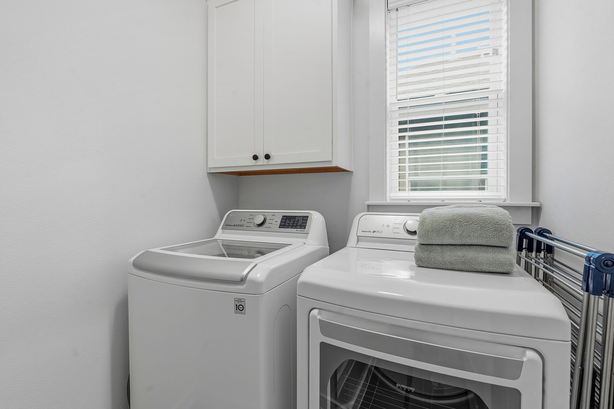 900 Old Mill Road, Unit 46 Cedar Park, TX 78613 - Photo 24 of 30 Laundry room featuring washing machine and clothes dryer and cabinet space