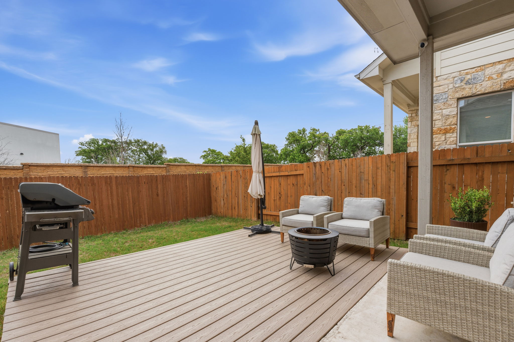 900 Old Mill Road, Unit 46 Cedar Park, TX 78613 - Photo 26 of 30 Deck with a grill, a fenced backyard, and an outdoor living space with a fire pit