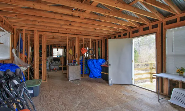 a view of an empty room with furniture and windows