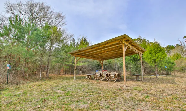 a backyard of a house with barbeque oven table and chairs