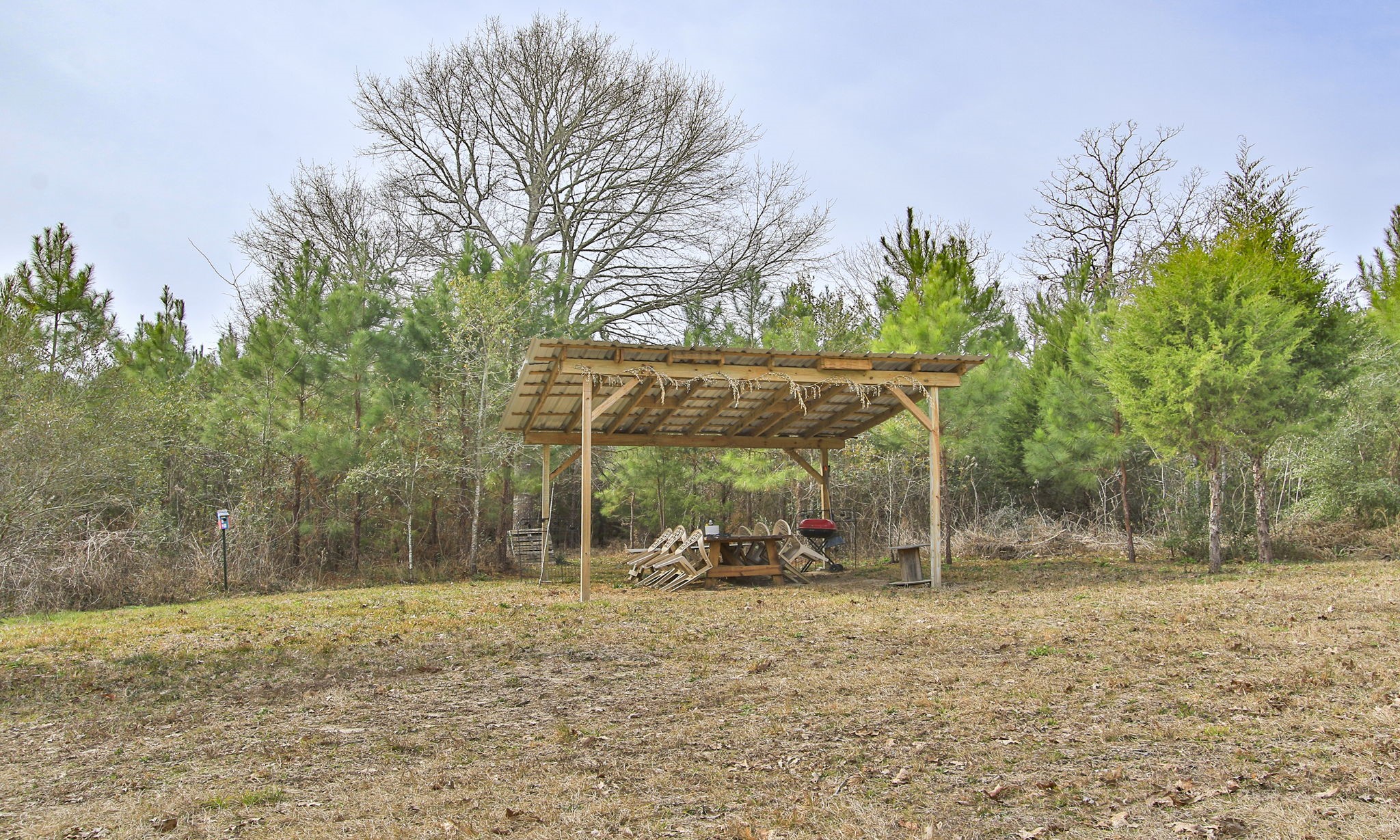 495 Pinecrest Drive Point Blank, TX 77364 - Photo 15 of 28 a backyard of a house with barbeque oven table and chairs