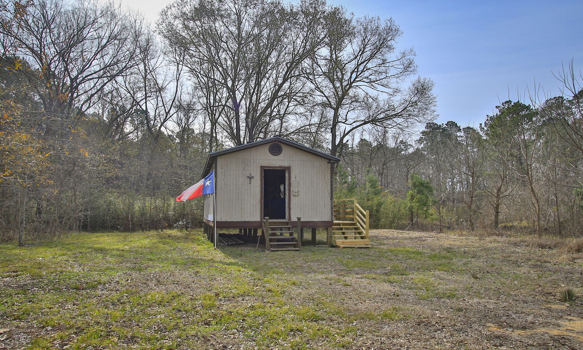 495 Pinecrest Drive Point Blank, TX 77364 - Photo 9 of 28 a backyard of house with swing and slide