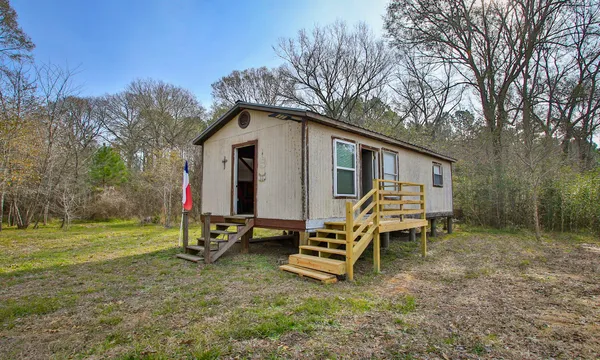 a view of water heater room with window and furniture