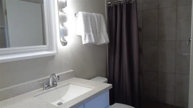 a bathroom with a sink vanity and a mirror