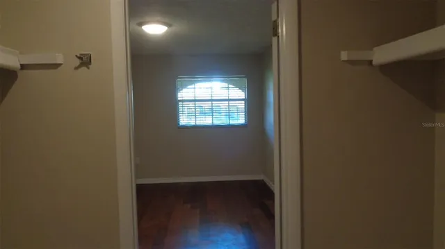 a view of a room with wooden floor and windows