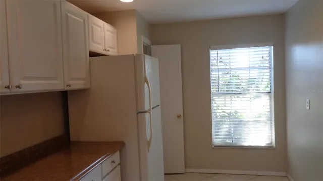 a refrigerator freezer sitting inside of a kitchen