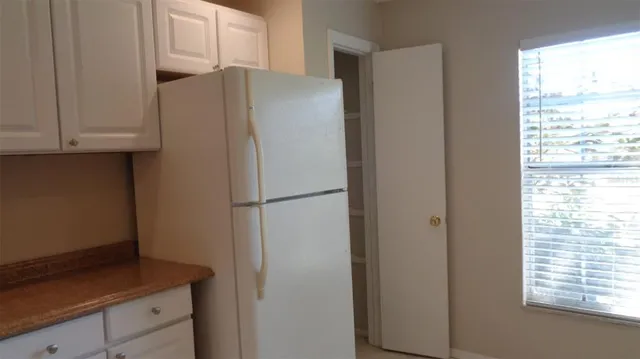 a white refrigerator freezer sitting in a kitchen