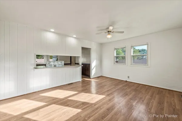 a view of a kitchen with wooden floor and a kitchen space