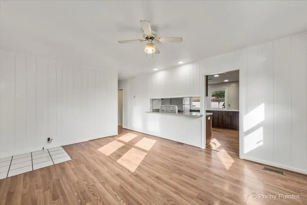 a view of a kitchen with wooden floor and a kitchen
