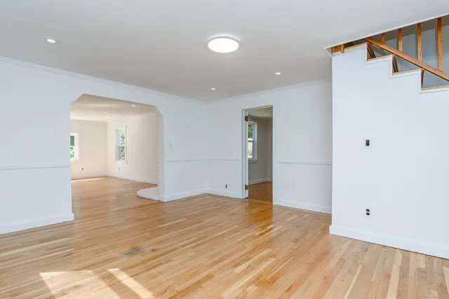 a view of an empty room and wooden floor