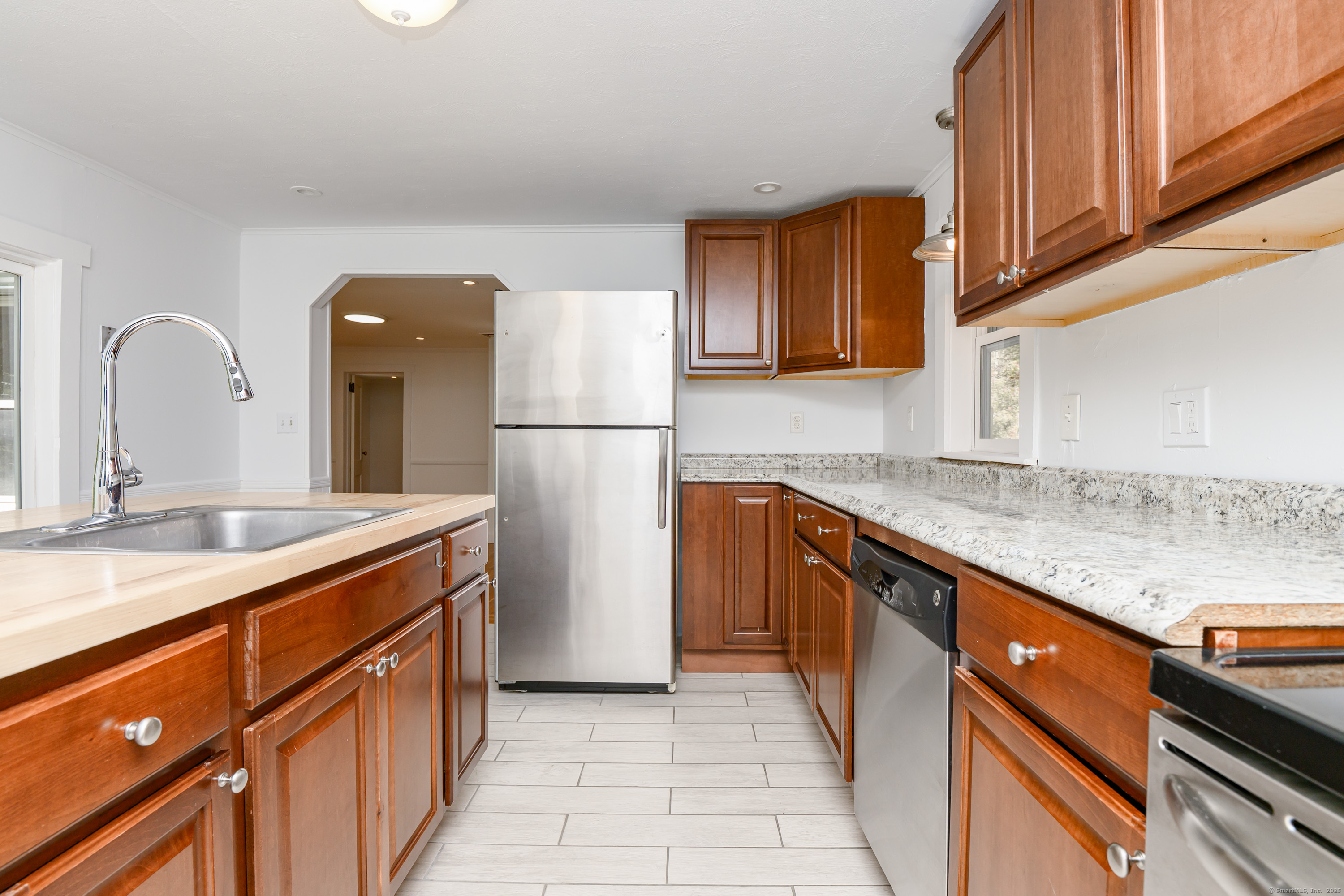 81 Picketts Ridge Road Redding, CT 06896 - Photo 14 of 28 a kitchen with a sink a refrigerator and a counter top space