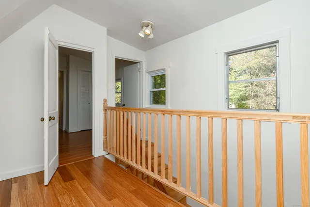 a view of a room with wooden floor and stairs