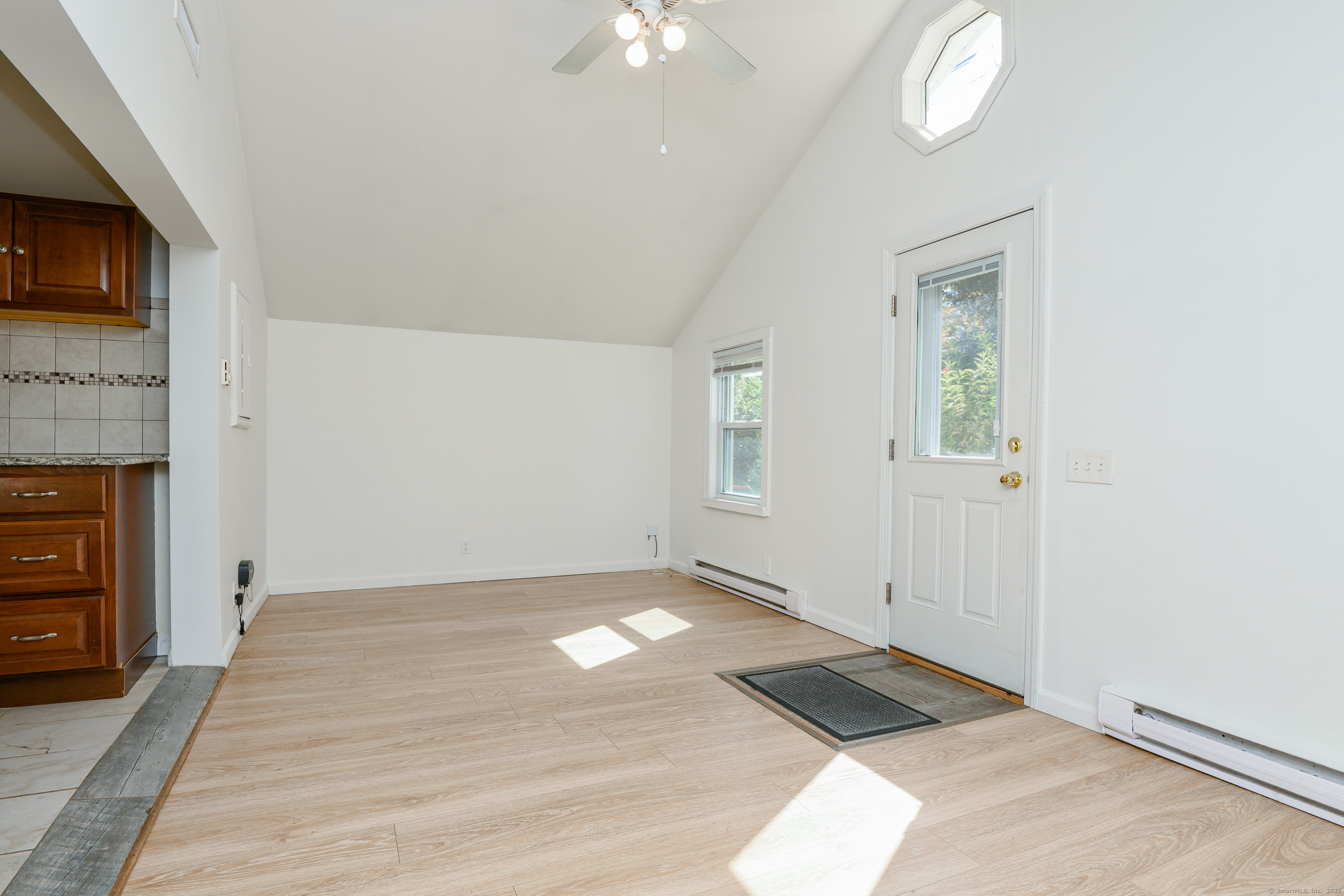 81 Picketts Ridge Road Redding, CT 06896 - Photo 24 of 28 an empty room with windows and fireplace