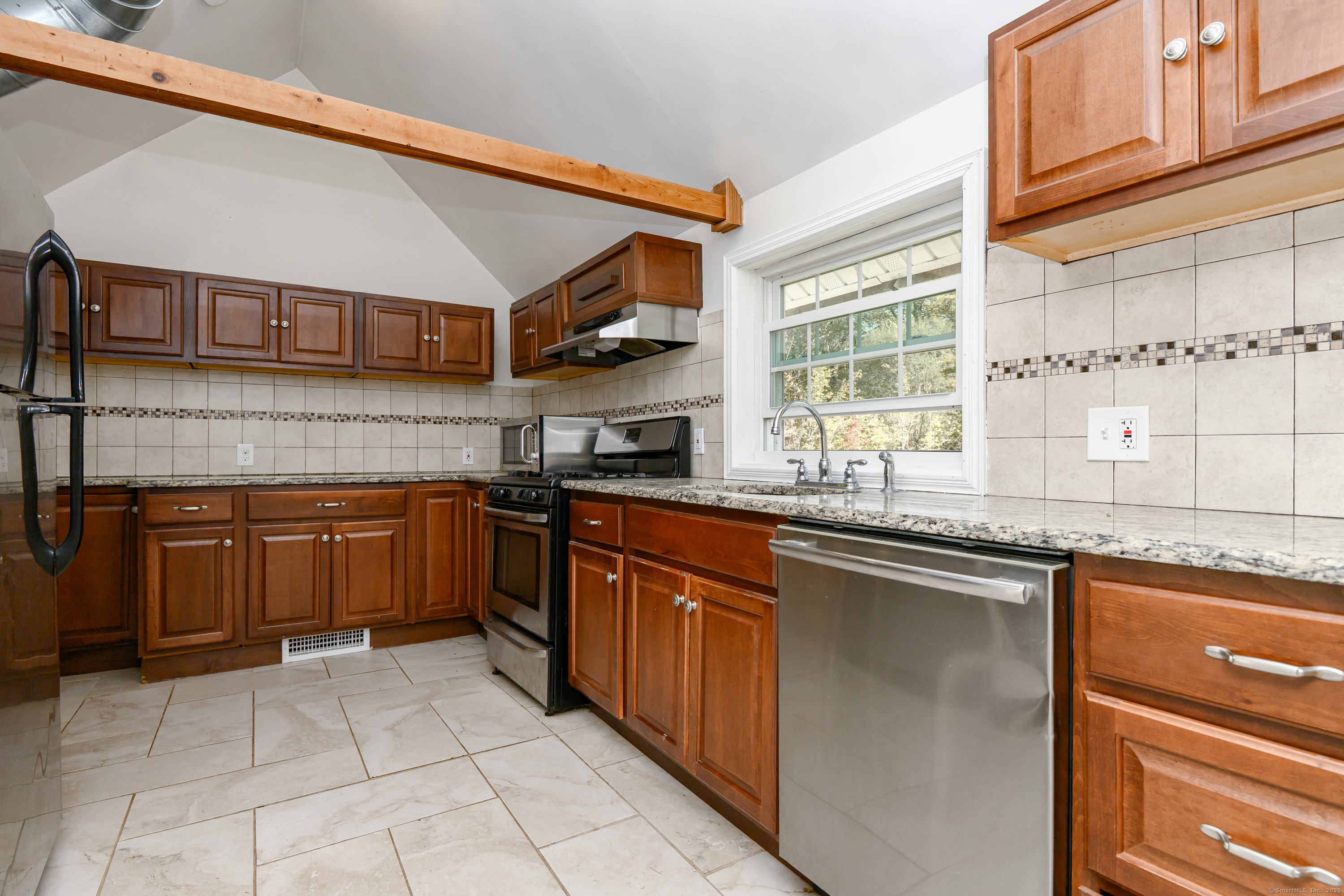 81 Picketts Ridge Road Redding, CT 06896 - Photo 25 of 28 a kitchen with stainless steel appliances granite countertop a stove sink and cabinets