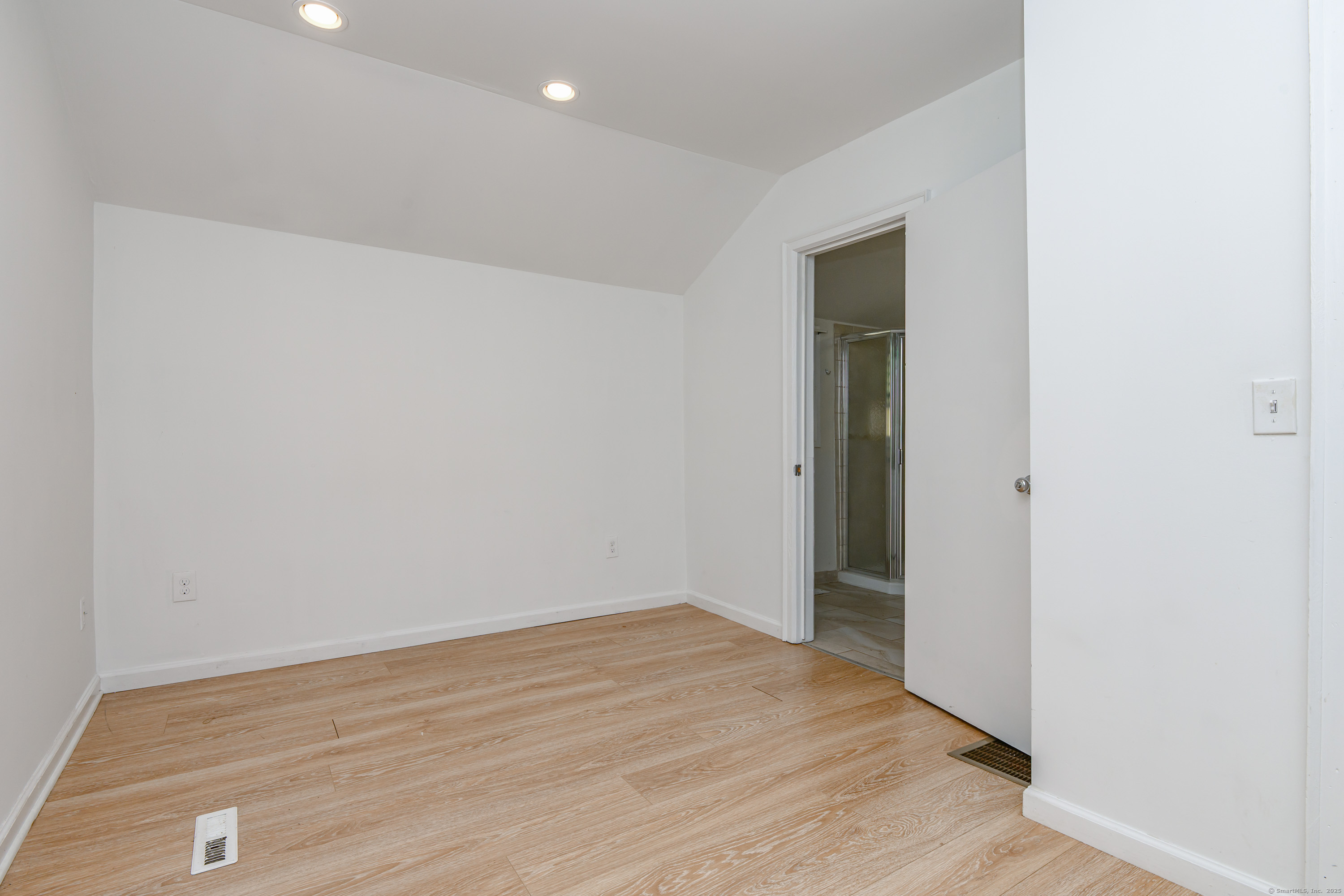 81 Picketts Ridge Road Redding, CT 06896 - Photo 26 of 28 an empty room with wooden floor and closet