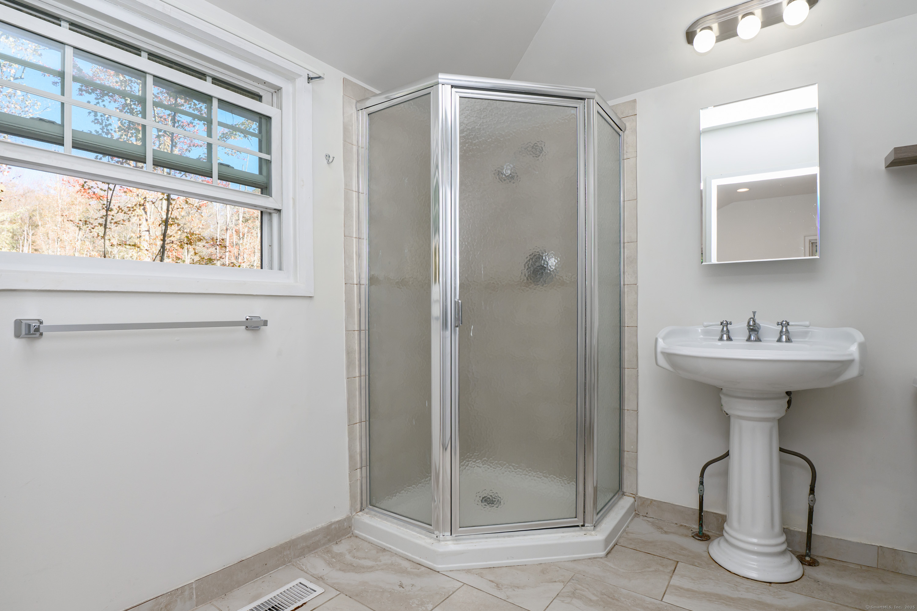 81 Picketts Ridge Road Redding, CT 06896 - Photo 27 of 28 a bathroom with a shower sink and mirror