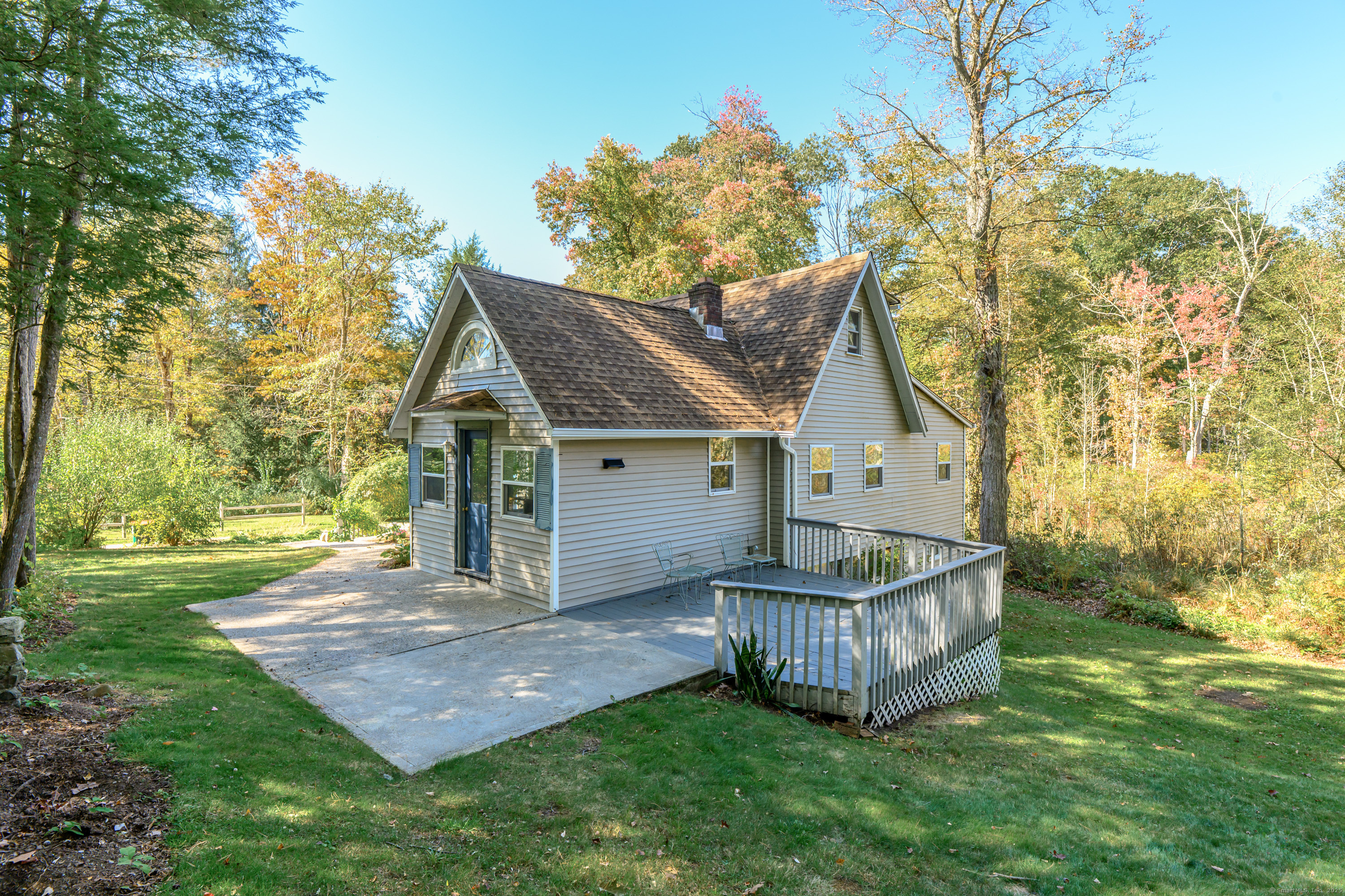 81 Picketts Ridge Road Redding, CT 06896 - Photo 4 of 28 a view of a house with wooden fence and trees