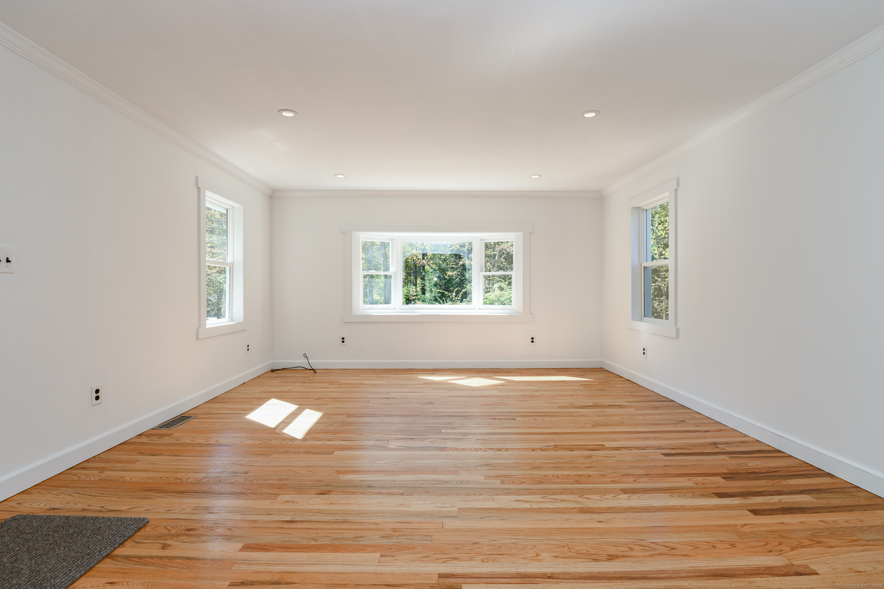 81 Picketts Ridge Road Redding, CT 06896 - Photo 8 of 28 a view of an empty room with wooden floor and a window
