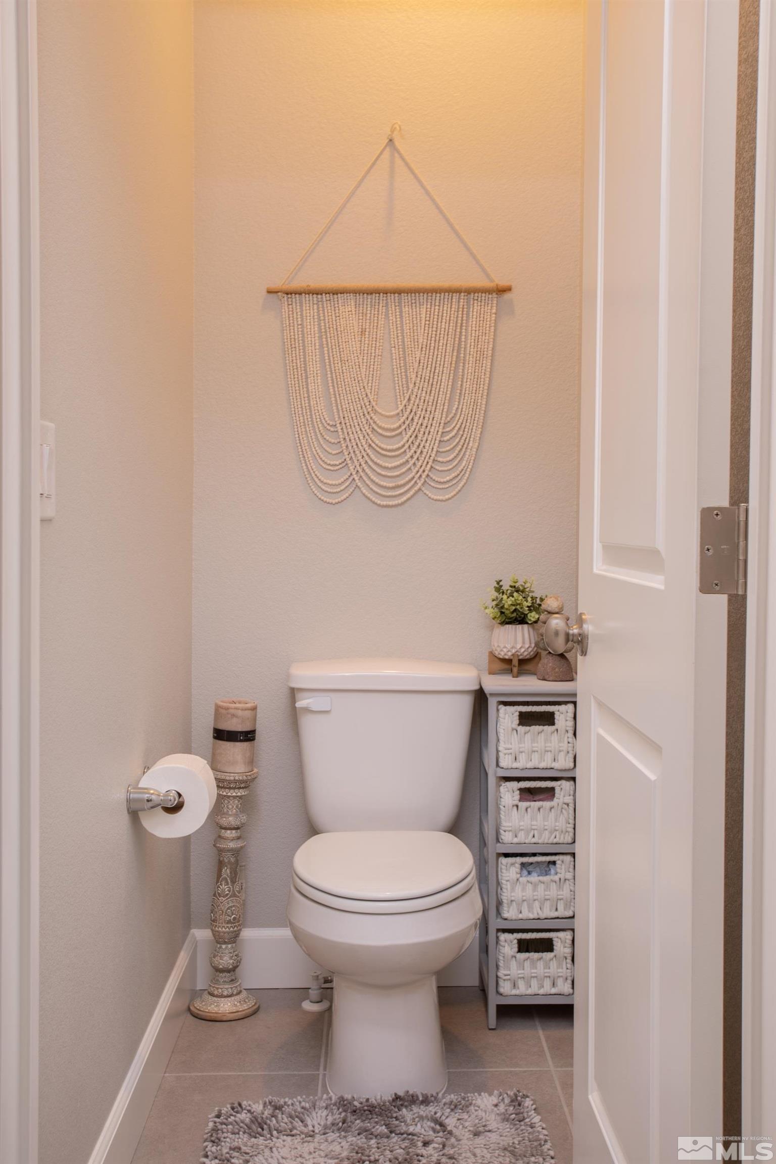 1864 Sea Horse Road, Unit A Reno, NV 89521 - Photo 12 of 17 a white toilet sitting next to a shower curtain
