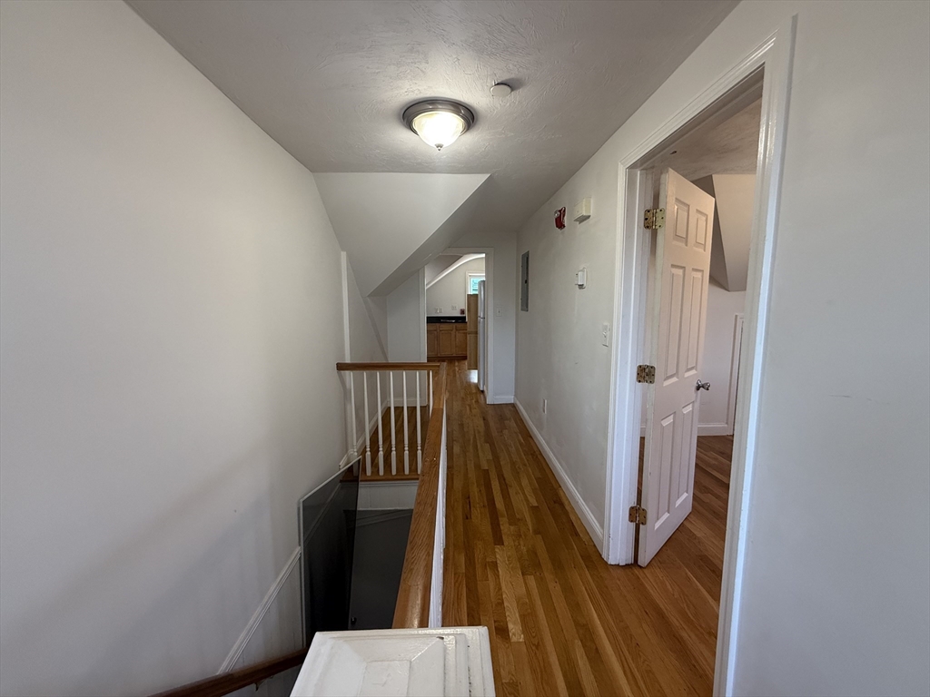 69 Beacon Street, Unit 3 Chelsea, MA 02150 - Photo 1 of 9 a view of a hallway with wooden floor and staircase