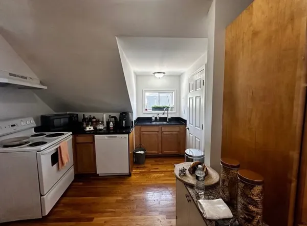 a kitchen that has a sink and a stove in it