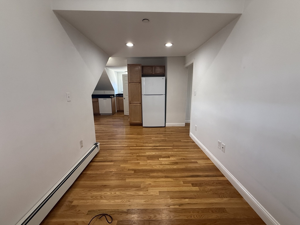 69 Beacon Street, Unit 3 Chelsea, MA 02150 - Photo 4 of 9 a view of a hallway with wooden floor